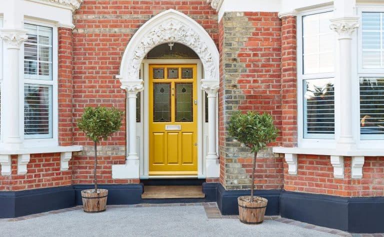 18 Inspiring Yellow Front Door Ideas for Brick Homes