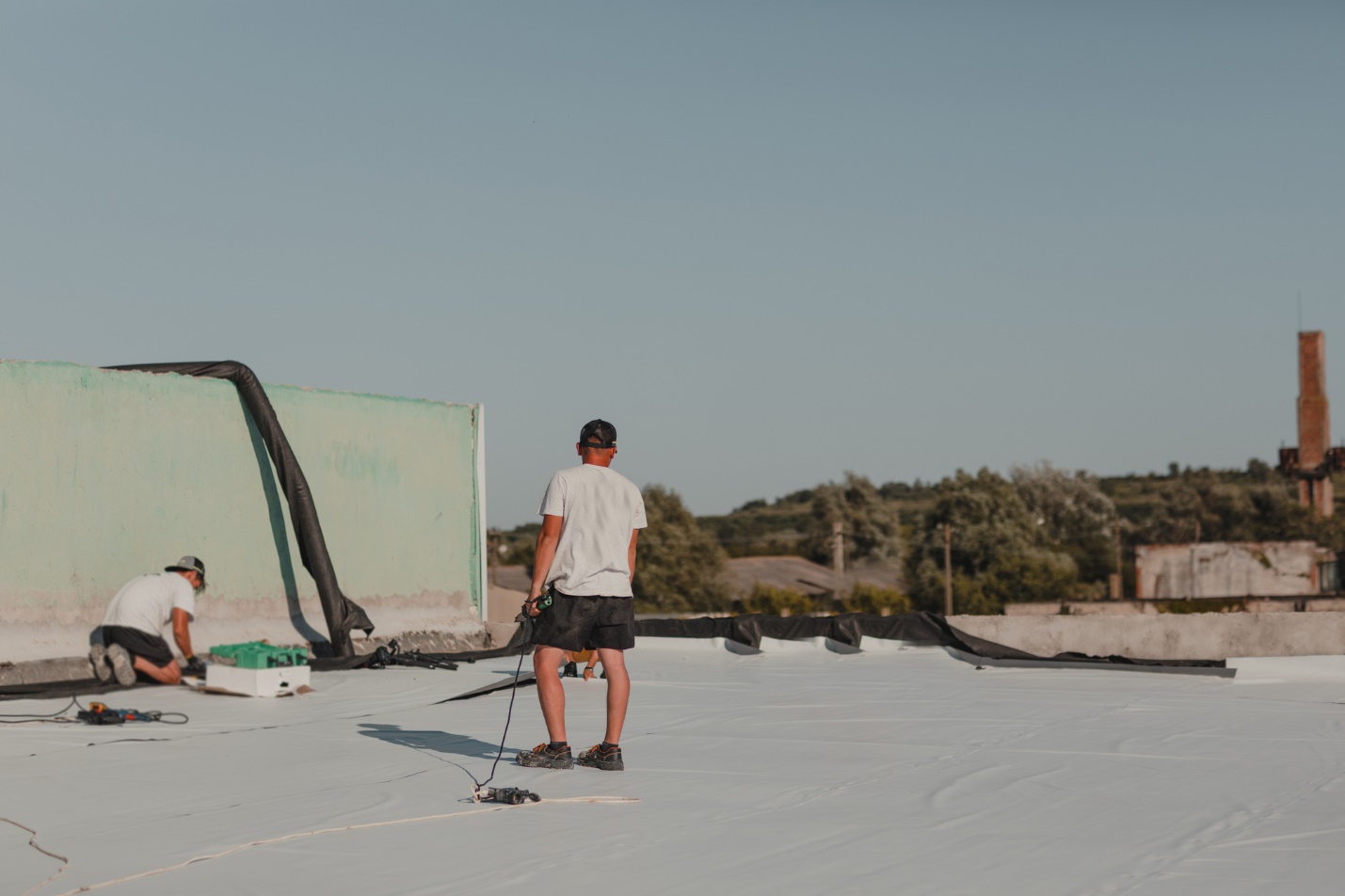 A person standing on a roof Description automatically generated