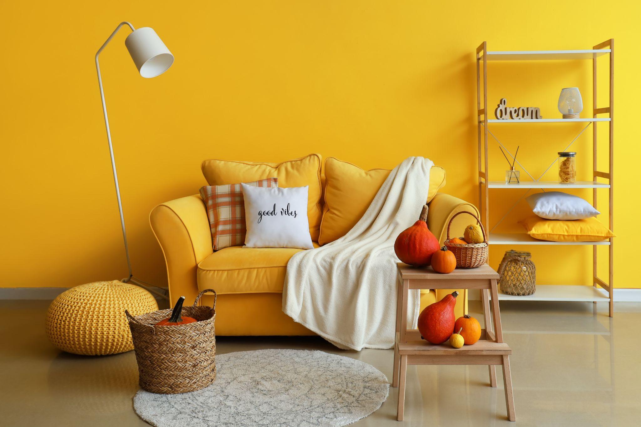 Interior of beautiful living room with sofa and autumn decor
