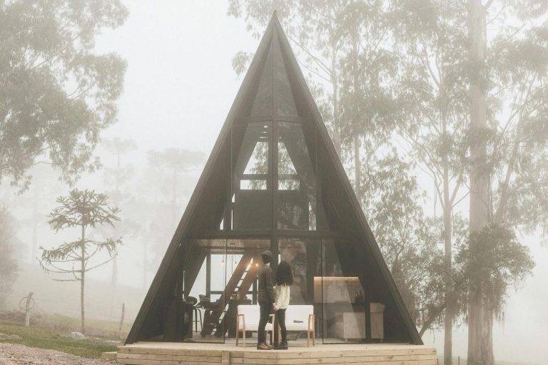 Couple in front of a triangular house