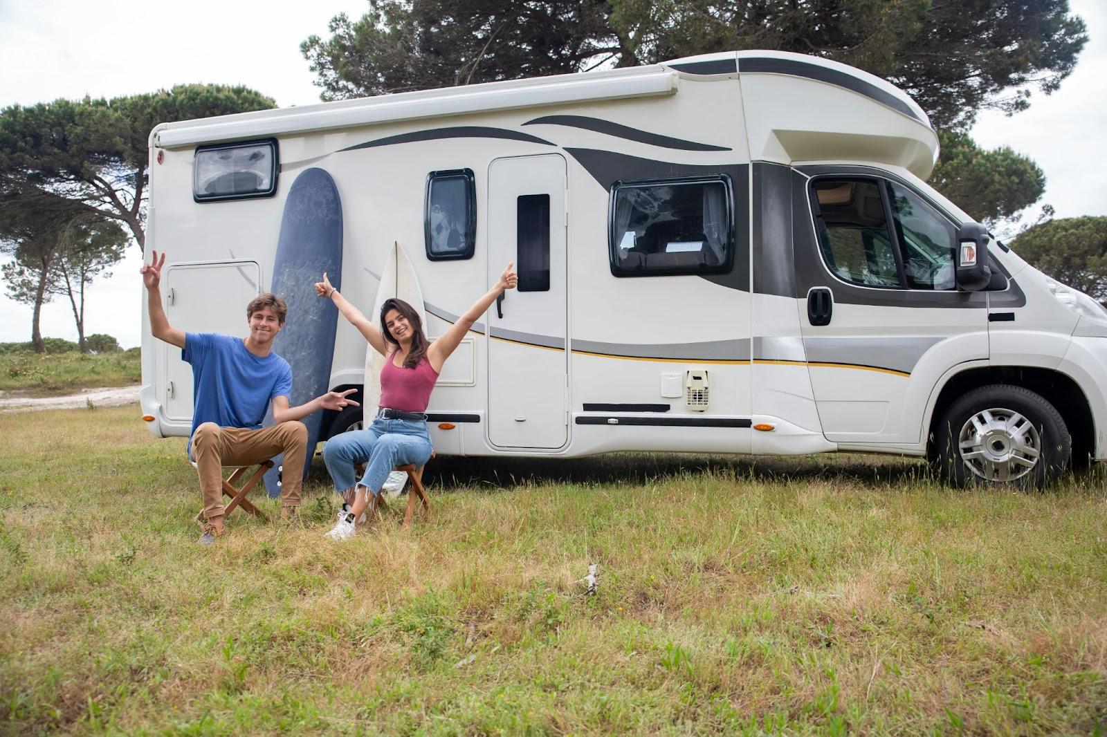 Couple sitting outside an RV