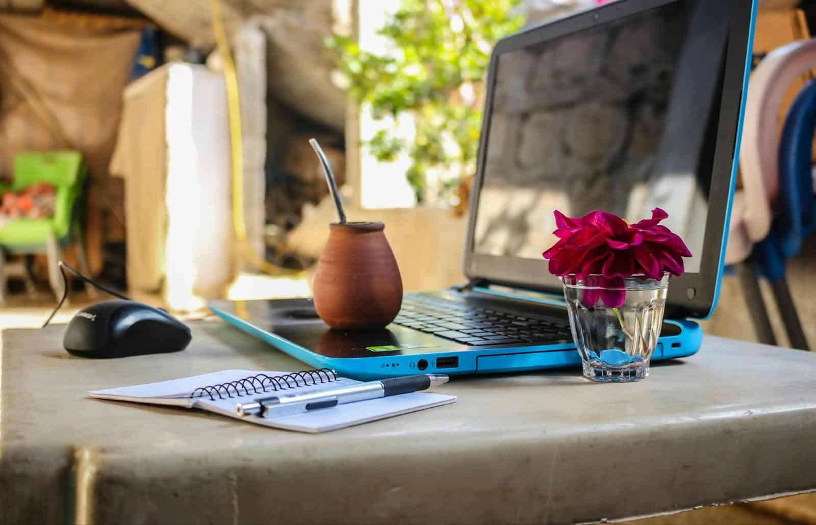 Notebook and laptop on outdoor table