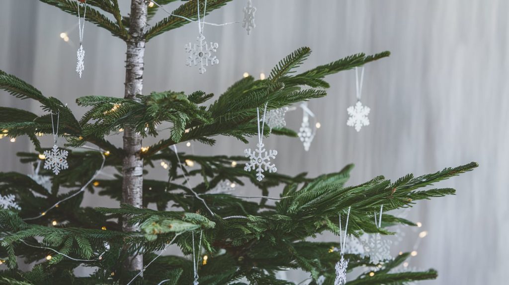 Modern Christmas Tree Styled with Silver Charms and Snowflakes