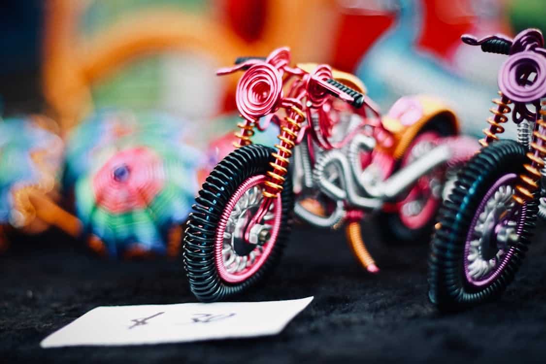 Free Artistic shot of wire-crafted motorbike models with vibrant colors and intricate details. Stock Photo