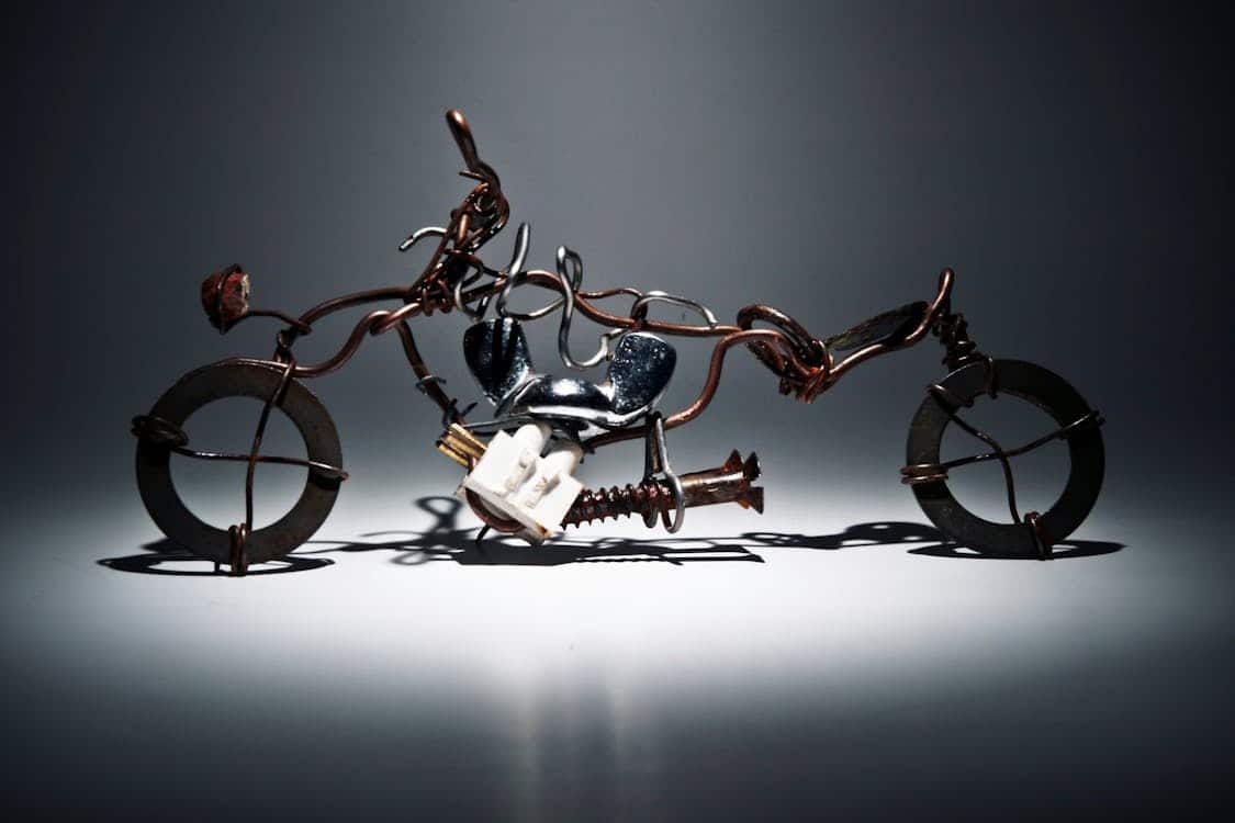 Free Creative recycled metal motorcycle sculpture made from wire and iron materials. Stock Photo