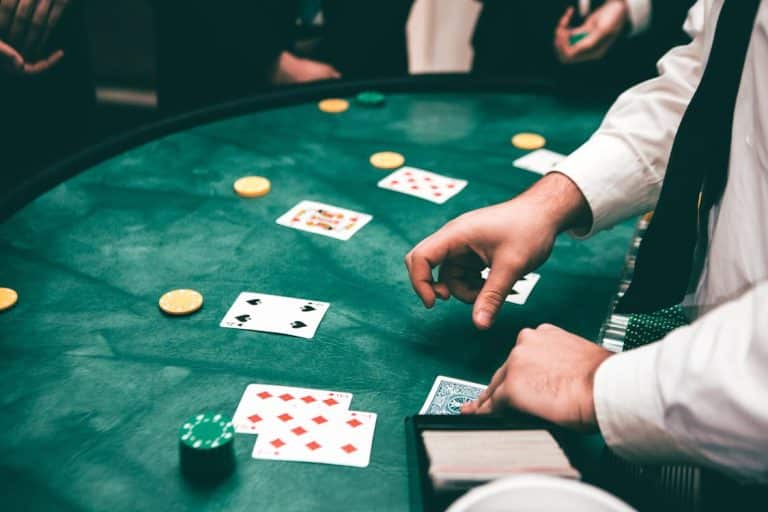 Free Casino scene with dealer and players, featuring cards and chips, creating a suspenseful atmosphere. Stock Photo