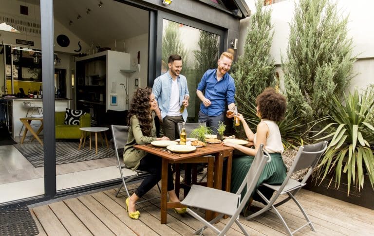 Friends grilling food and enjoying barbecue party outdoors