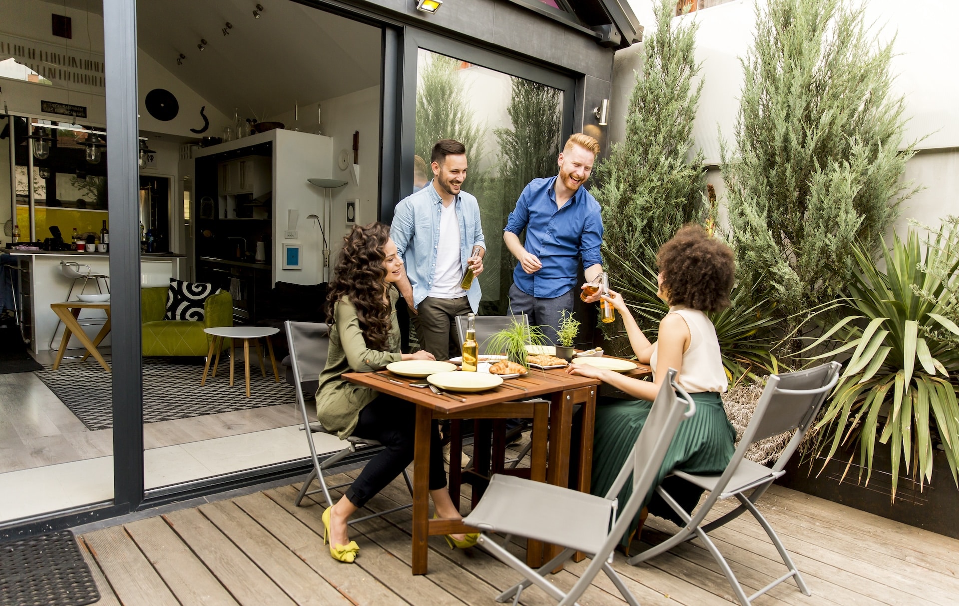 Friends grilling food and enjoying barbecue party outdoors