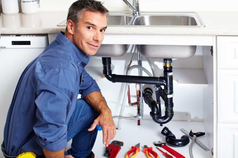 A person working on a sink AI-generated content may be incorrect.