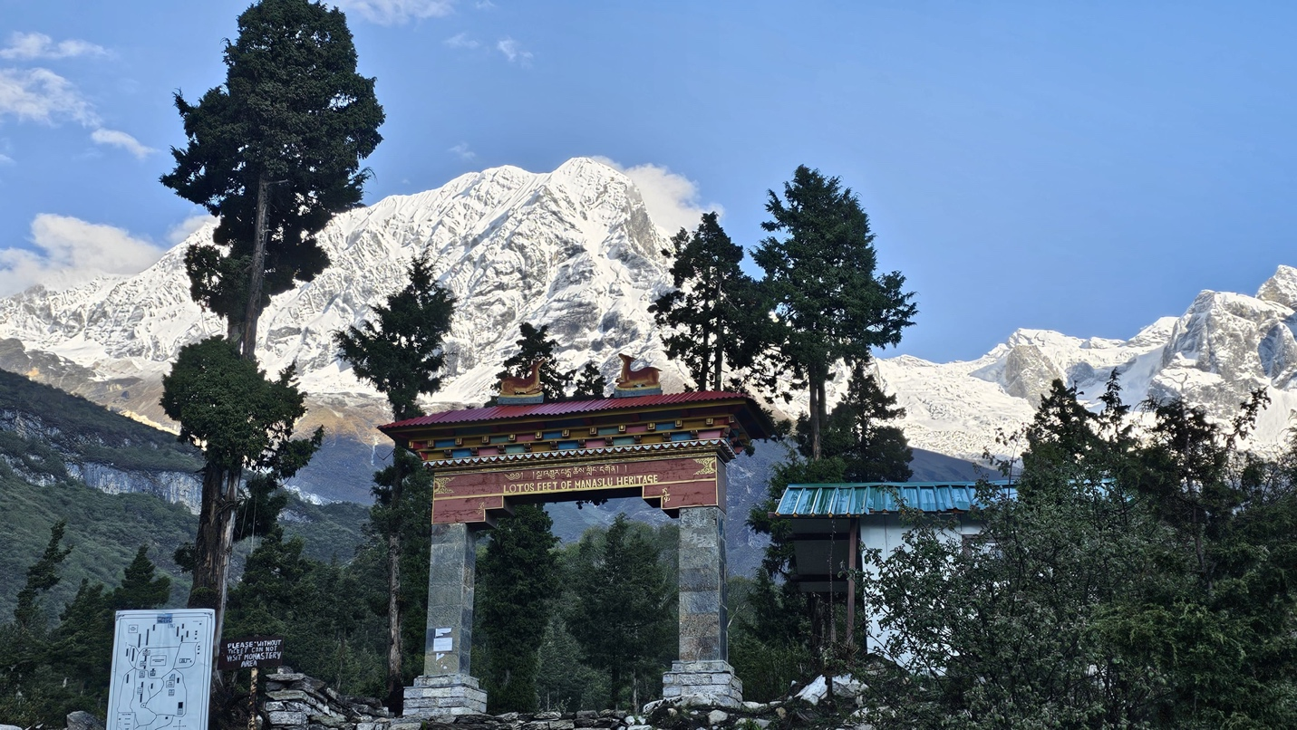A stone archway with trees and mountains in the background AI-generated content may be incorrect.