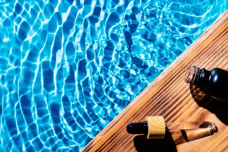 Facial pipette serum oil, essence cosmetic product, water pool splashing fresh transparent. Flat lay, top view. Summer, beach natural, vacation. Organic skin body anti age care in hot climate